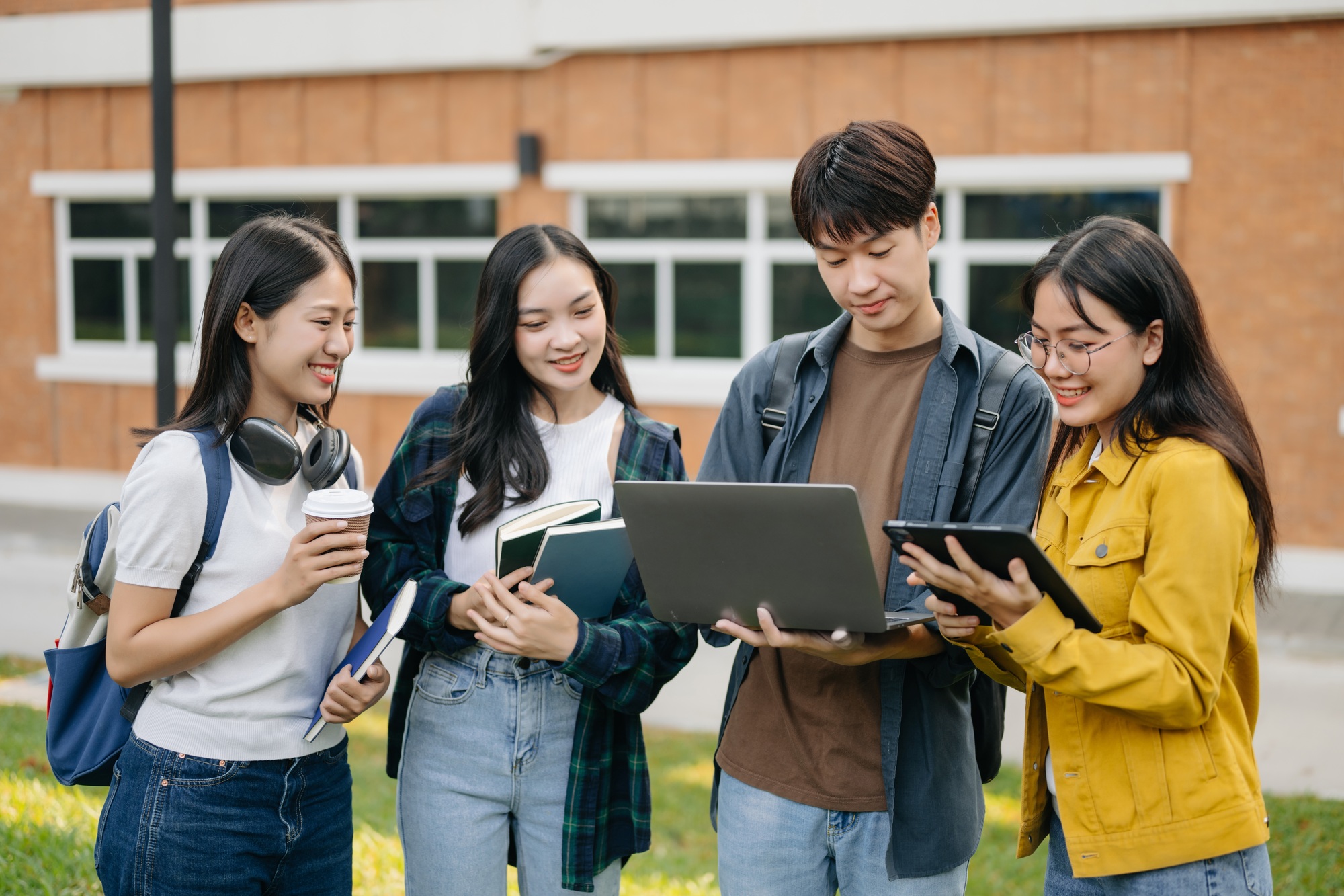 Asian Students are studying the campus park. Young people are spending time together.